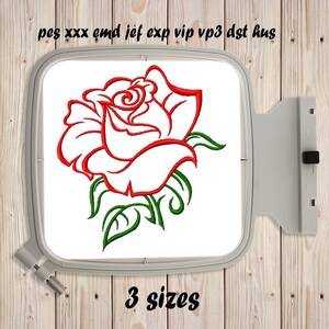 May include: An embroidery hoop containing a machine embroidery design of a red rose with green leaves and stems. The text "pes xxx emd jef exp vip vp3 dst hus" is printed above the hoop, and the text "3 sizes" is printed below the hoop.