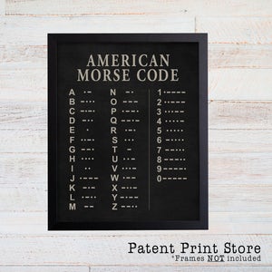 May include: A black framed print with a white background and the text "AMERICAN MORSE CODE" in a large font. The print lists the letters of the alphabet and numbers 1-0 with their corresponding Morse code symbols.