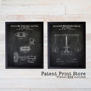 May include: Two black framed prints of vintage patent drawings on a white wood background. The left print shows a drawing of a hollow headed gavel with the text "Hollow Headed Gavel, A.J. Quayle, July 24, 1908, No. 2,755,853". The right print shows a drawing of a balance weighing scale with the text "Balance Weighing Scale, W.B. Guild, Sept. 29, 1905, No. 326,75". The text "Patent Print Store, *Frames NOT included" is below the prints.