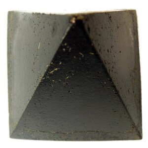 May include: A solid black pyramid-shaped object with a textured, porous surface. The four triangular faces meet at a central apex, and the base is square. The material appears dark and matte with small indentations and flecks across the surface.