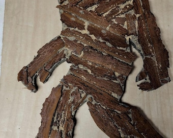 Hand carved and designed Bigfoot.  Made from tree bark.