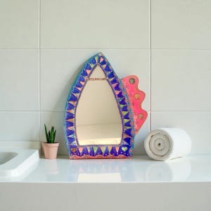 blue mirror and colors, asymmetrical shape, functional art for wall decoration, parties, in paint and glass and bead mosaic