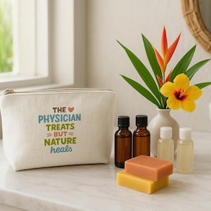 May include: A beige canvas cosmetic bag with the text "THE PHYSICIAN TREATS = BUT NATURE heals" in blue and green. Beside it are brown essential oil bottles, small white bottles, and two bars of soap. A vase holds a yellow flower and green leaves.