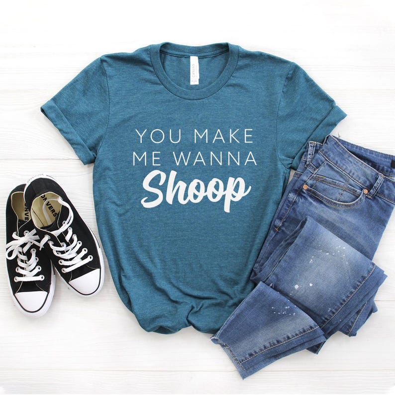 May include: Teal blue t-shirt with the text "You make me wanna Shoop" in white.