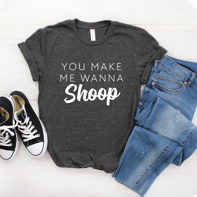 May include: A dark gray t-shirt with the text "You make me wanna Shoop" in white lettering.