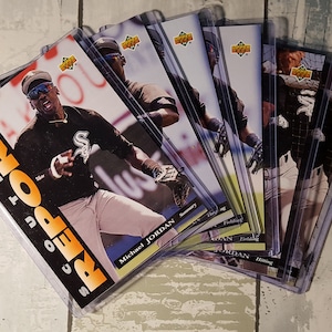 May include: A stack of 10 baseball trading cards featuring Michael Jordan in a Chicago White Sox uniform. The cards are in protective plastic sleeves. The cards are from the 1994 Score set.
