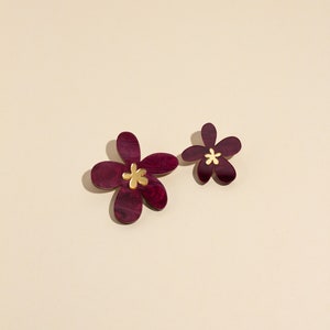 A pair of plum purple acrylic statement flowers earrings in size small and Large.