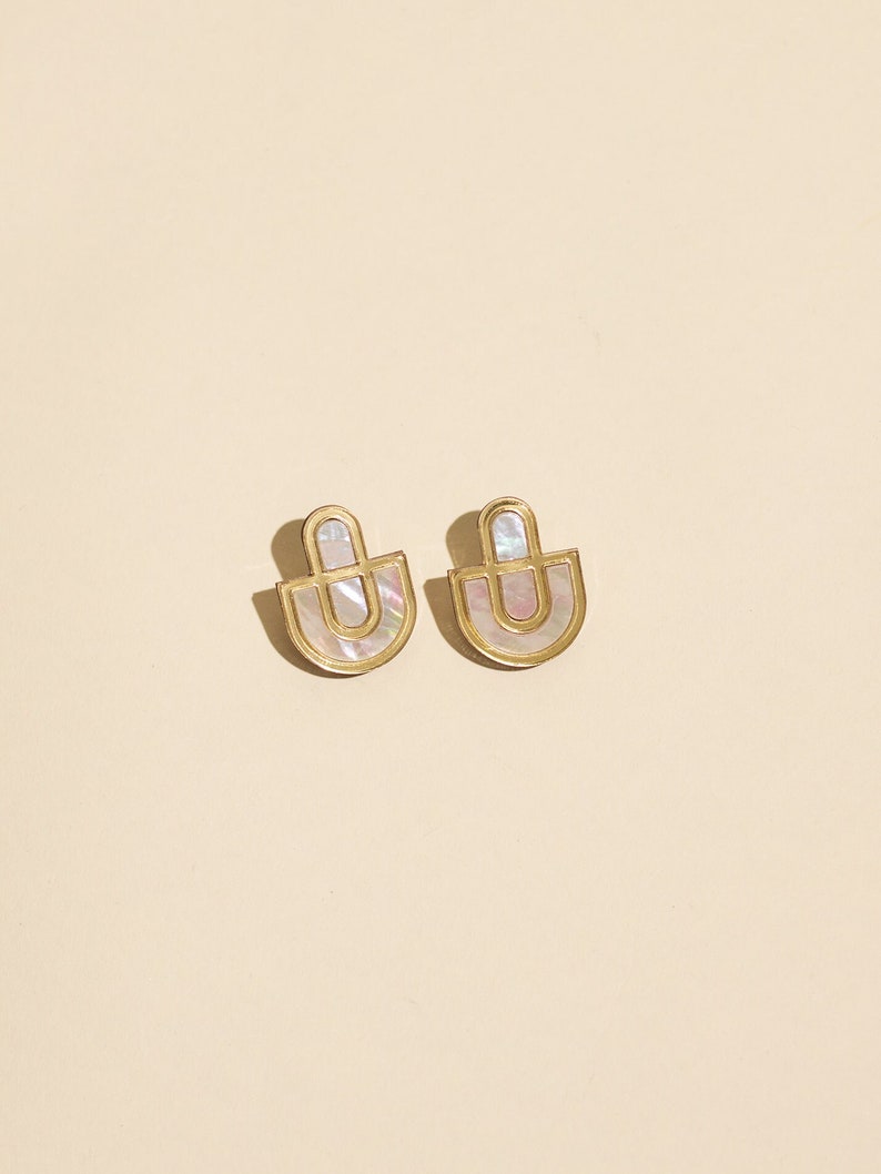 A pair of Mother of Pearl and acrylic statement stud earrings