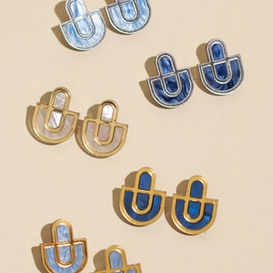 A group photo of acrylic statement stud earrings in different colors.
