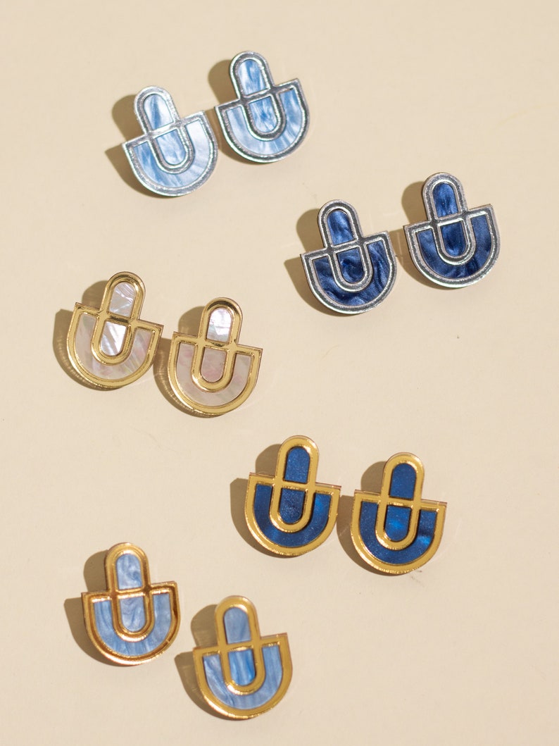 A group photo  of acrylic statement stud earrings in different colors.