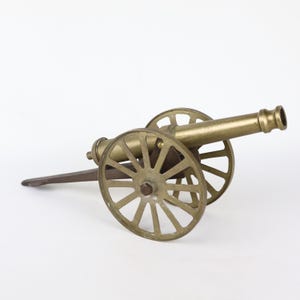 Field cannon model with brass barrel on a brass carriage with rolling brass wheels 12 inches long