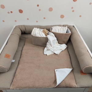 Könnte beinhalten: Ein Set aus drei Keramikbechern mit gesprenkelter, matter Oberfläche. Die Becher sind in Creme-, Hellgrau- und Dunkelgrautönen gehalten. Jeder Becher hat ein schlichtes, minimalistisches Design.