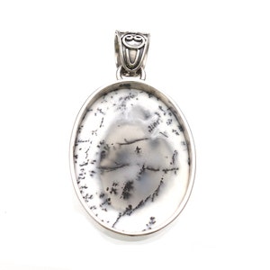May include: A silver pendant with an oval-shaped dendritic agate stone. The stone is white with black dendritic patterns.