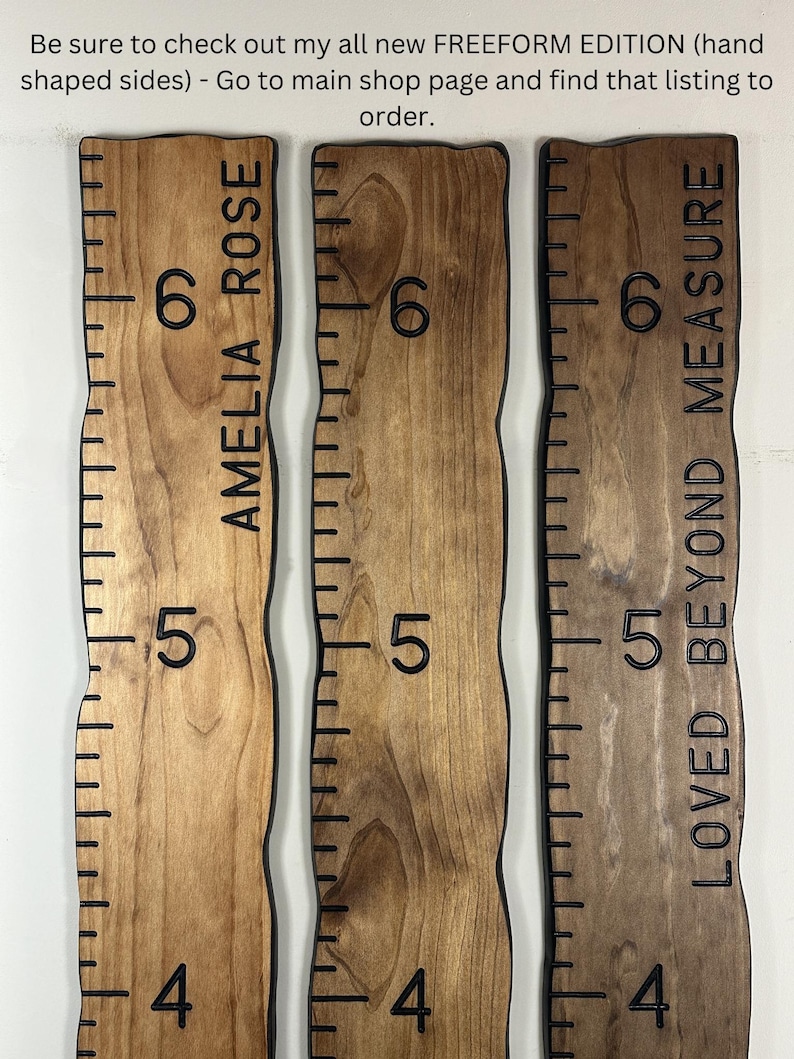 May include: Three wooden growth charts with black measurements and text. The charts are in shades of brown and have wavy edges. One chart reads "AMELIA ROSE", another reads "LOVED BEYOND MEASURE". The charts are marked with numbers 4, 5, and 6.