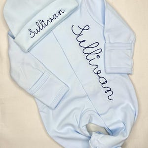 May include: A set of three ceramic mugs with a speckled, matte finish. Each mug features a different color: light blue, cream, and gray. The mugs have a simple, modern design and a comfortable handle. Perfect for coffee or tea.