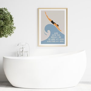 May include: A framed print with a minimalist illustration of a person diving into a blue wave. The text below the image reads "And into the ocean I go to lose my mind and find my soul."