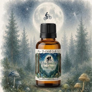 Op de afbeelding: Een amberkleurige glazen druppelfles met een zwarte dop, voorzien van een etiket met de tekst Main Street Melts Candle Co. Extra-Terrestrial Forest Flight. Het etiket toont een silhouet van twee figuren op een fiets voor een volle maan.