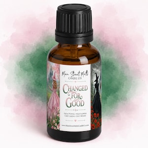 May include: An amber glass bottle with a black dropper cap featuring a label that reads Main Street Melts Candle Co. Changed For Good. The label displays two figures in a landscape with text listing Fresh Poppies, Wild Flowers, Crisp Greens, Soft Woods.