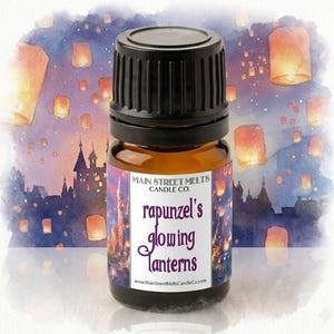May include: A small amber glass bottle with a black cap, labeled "Rapunzel's Glowing Lanterns" from Main Street Melts Candle Co. The label features a watercolor illustration of floating lanterns and a castle silhouette against a night sky background.