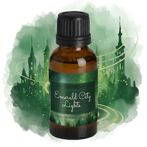 May include: A small amber glass bottle with a black screw-top cap. The label features a green watercolour background with a silhouette of a city skyline and the text "Main Street Melts Candle Co. Emerald City Lights www.MainStreetMeltsCandleCo.com".