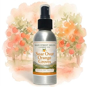 May include: A silver metal spray bottle with a black pump top. The label features the text Main Street Melts Candle Co. Soar Over Orange Groves, Prepare For Takeoff, and a website URL, set against a watercolour illustration of orange trees.