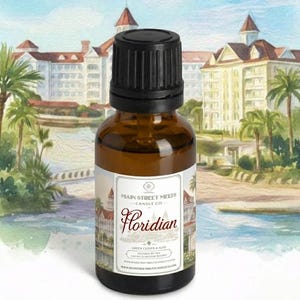 May include: A small amber glass bottle with a black ribbed dropper cap. The white label features the text Main Street Melts Candle Co. Floridian, Green Clover & Aloe, and a watercolor illustration of a large resort building with palm trees.