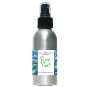 May include: A silver spray bottle with a black cap and a label that reads "Main Street Melts Candle Co. Pixie Dust" with a blue and green illustration of clouds and a beach.