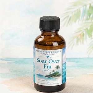May include: A small amber glass bottle with a black screw-top lid. The label features the text Main Street Melts Candle Co. and Soar Over Fiji, with an illustration of a tropical island, palm trees, and a hang glider above blue ocean water.