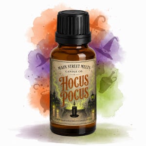 May include: A small amber glass bottle with a black cap, featuring a label that reads Main Street Melts Candle Co. Hocus Pocus. The label depicts a black cauldron, lit candles, and a dark house silhouette against a watercolor background.