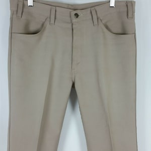 May include: A pair of beige straight-leg pants with a button fly and two front pockets.