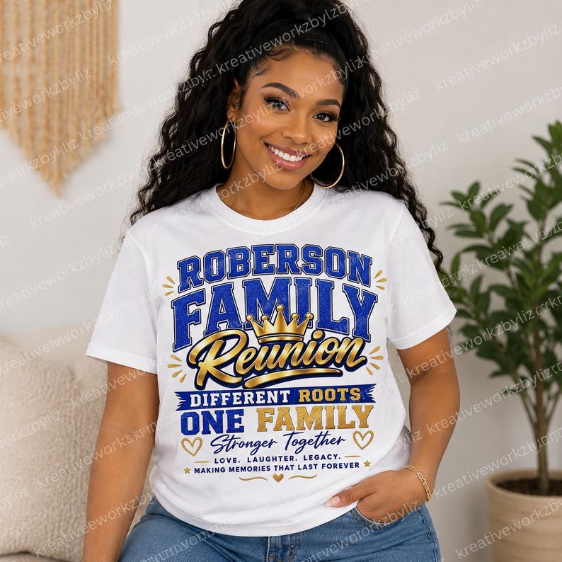 May include: White t-shirt with a blue and gold design that reads "ROBERSON FAMILY REUNION". The shirt also includes the text "DIFFERENT ROOTS ONE FAMILY STRONGER TOGETHER" with hearts and stars. A crown is in the center.