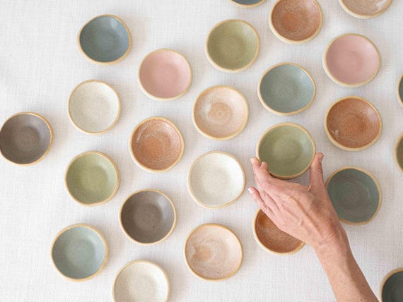 Hand-thrown stoneware with an organic, earthy feel — the kind of tiny dish that instantly elevates a nightstand or kitchen counter.