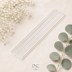 May include: A set of clear, cylindrical glass straws arranged in a parallel row. The straws are transparent with a smooth, straight design. The logo for CNC-N-CRAFT.UK is printed in black at the bottom centre of the image.
