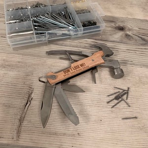 May include: A multi-tool with a hammer, knife, and other tools. The handle is made of wood and has the text "DON'T LOSE ME! With love from Musa" engraved on it.