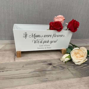 Può includere: Vaso da fiori in metallo bianco con gambe in legno, con il testo "If Mums were flowers... We'd pick you!" e "Lots of love Sammy & Peter". Il vaso è decorato con rose artificiali in tonalità rosa, rosso e crema.