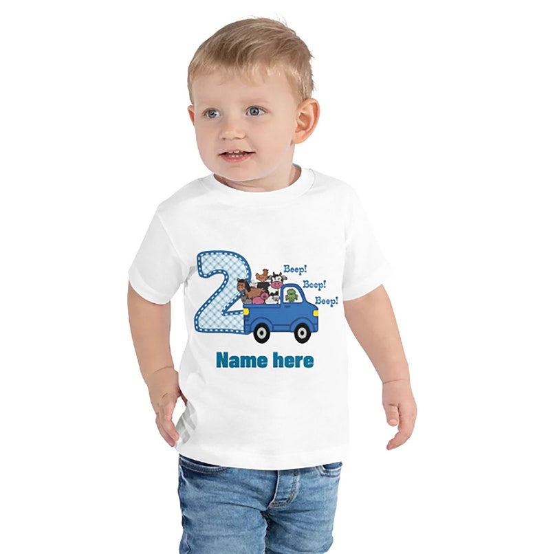 May include: White toddler t-shirt with a blue number 2, a blue truck with farm animals, and the text "Beep! Beep! Beep!" and "Name here".