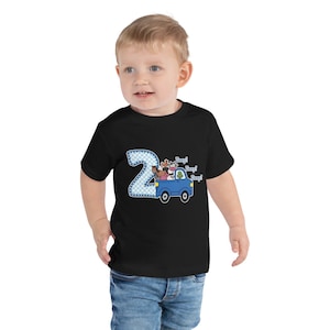 May include: A black toddler t-shirt with a blue truck carrying farm animals. The truck has a number "2" on the side and the text "Beep! Beep! Beep!" above the truck.