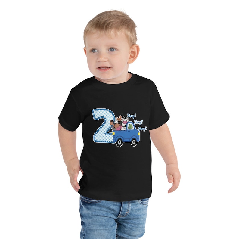 May include: A black toddler t-shirt with a blue truck carrying farm animals. The truck has a number "2" on the side and the text "Beep! Beep! Beep!" above the truck.