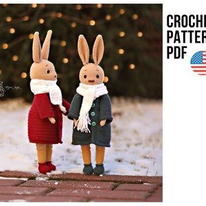 May include: Two crocheted bunny dolls wearing coats and scarves, standing on a brick surface. One bunny wears a red coat and the other a dark green coat. The text "CROCHET PATTERN PDF" is displayed with a US flag.