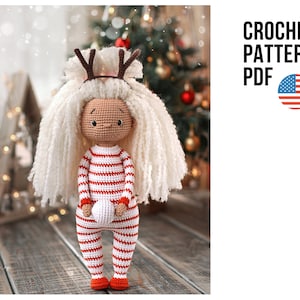 May include: Crochet pattern PDF for a cute, white-haired doll wearing a red and white striped outfit and reindeer antlers. The doll is holding a small white ball.
