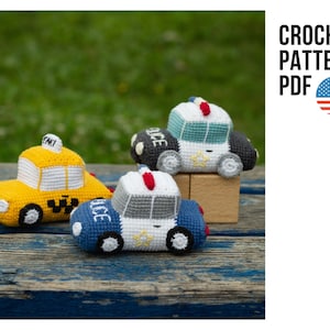 Puede incluir: Patrón de crochet PDF para tres coches de juguete amigurumi: un taxi amarillo, un coche de policía azul y gris y un coche de policía azul verdoso y gris. Los coches están sobre una superficie de madera.