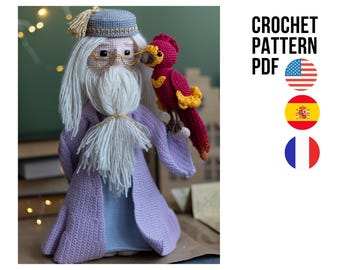 May include: Crochet pattern PDF for a purple and white crocheted wizard doll with a gray hat and a red and orange crocheted bird. The pattern is available in English, Spanish and French.