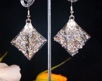 Handmade dichroic glass earrings, a larger version of the wavy diamond shape with dichroic glass frit. 5/8 x 5/8 and 1 x 1&quot;, glass earrings.