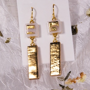 Elegance-24 karat Gold Filigree on White with Gold bar, hand made fused glass earrings, sue to dress up any outfit. 2 1/4 x 1/2"