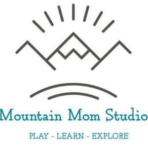 May include: A logo for Mountain Mom Studio, a business that offers play, learning, and exploration opportunities. The logo features a stylized mountain range with a sunburst above it. The text "Mountain Mom Studio" is in a blue font, and the text "PLAY - LEARN - EXPLORE" is in a smaller, gray font.