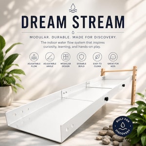 May include: A white modular indoor water flow system titled DREAM STREAM. The unit features a long, white channel with adjustable wooden supports. Text highlights include adjustable flow, angle, modular design, durable build, and easy cleaning.