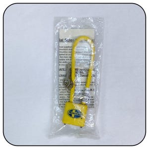 May include: A yellow padlock with a silver key attached to a yellow rubber strap. The padlock has the text "MOSSBERG" printed on it.