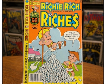 May include: A vintage Richie Rich Riches comic book, issue number 49, featuring a yellow-haired character jumping into a pile of pearls with a speech bubble saying, WOW! THAT'S SOME PEARL-VAULT, RICHIE! The cover is orange with blue and yellow text.