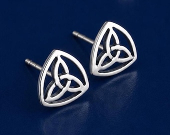 May include: A pair of silver stud earrings featuring a triangular frame with an openwork triquetra knot design. Each earring has a post back and a polished metallic finish, showcasing a classic Celtic-inspired geometric pattern in silver.