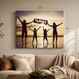 May include: A rectangular wall canvas print measuring 30 inches by 24 inches, featuring a silhouette of a family of four standing on a beach at sunset. The two adults and two children have their arms raised, holding a sign that reads FAMILY.